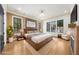 Luxurious main bedroom boasts hardwood floors, recessed lighting, and a plush bed at 942 Fairfield Dr, Marietta, GA 30068