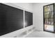 Mudroom features a black accent wall, built in benches, and a view through a black frame window at 942 Fairfield Dr, Marietta, GA 30068