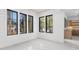 Bright room featuring black framed windows with views of the landscaped yard and white tile flooring at 942 Fairfield Dr, Marietta, GA 30068
