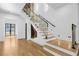 Modern staircase with glass railings, wood treads, and accent lighting create a stylish focal point at 942 Fairfield Dr, Marietta, GA 30068