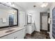 Bright bathroom with double sink, large mirror, tile flooring, and a glass enclosed shower room at 1145 Verandah Se Ln, Atlanta, GA 30316