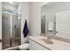 Well-lit bathroom featuring a glass shower, a sink with large mirror, and tile floors at 1145 Verandah Se Ln, Atlanta, GA 30316