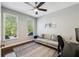 Comfortable bedroom featuring two windows, hardwood floors, ceiling fan, and a desk at 1145 Verandah Se Ln, Atlanta, GA 30316