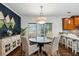Dining room with round table, elegant light fixture, and stylish blue accent wall at 1145 Verandah Se Ln, Atlanta, GA 30316