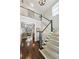 Spacious entry foyer with hardwood floors, staircase with carpet runner, and views into the adjacent living area at 1145 Verandah Se Ln, Atlanta, GA 30316