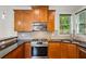 Stylish kitchen featuring stainless steel appliances, custom cabinets, and granite countertops at 1145 Verandah Se Ln, Atlanta, GA 30316
