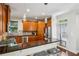 Open kitchen with stainless steel appliances, breakfast bar, custom cabinets, and a door to the backyard at 1145 Verandah Se Ln, Atlanta, GA 30316