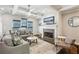 Cozy living room with coffered ceilings, fireplace with stone surround, and ample natural light from large windows at 1145 Verandah Se Ln, Atlanta, GA 30316