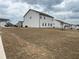 Wide backyard view of a two-story home with white siding, a large lawn, and a residential neighborhood at 14 Ledgemont Way, Acworth, GA 30101