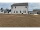 Backyard view of a two-story home with white siding, a well-maintained lawn, and rear patio at 14 Ledgemont Way, Acworth, GA 30101