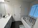 Well-lit bathroom featuring a soaking tub and vanity with modern fixtures at 14 Ledgemont Way, Acworth, GA 30101