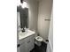 This bathroom has a stylish vanity and toilet with modern fixtures at 14 Ledgemont Way, Acworth, GA 30101