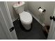Modern bathroom featuring sleek fixtures, a toilet, and stylish black tile flooring at 14 Ledgemont Way, Acworth, GA 30101