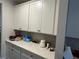 Butler's pantry with stylish cabinets, granite countertop and mosaic backsplash at 14 Ledgemont Way, Acworth, GA 30101