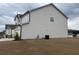 Side view of a two-story home with white siding and an attached two-car garage at 14 Ledgemont Way, Acworth, GA 30101