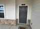 Close up of the front door showcasing stone accents, a house number, and a welcome mat at 14 Ledgemont Way, Acworth, GA 30101