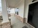 A covered front porch with stone pillars and a view of the neighborhood through the open door at 14 Ledgemont Way, Acworth, GA 30101