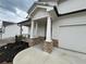 View of the front porch showing the walkway, stone pillars, and entrance to the home at 14 Ledgemont Way, Acworth, GA 30101