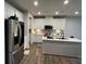 Modern kitchen featuring stainless steel appliances, white cabinets, quartz countertops and wood-look flooring at 14 Ledgemont Way, Acworth, GA 30101