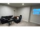 Comfortable living room featuring a cozy dark gray sofa, armchair, with natural light from a window at 14 Ledgemont Way, Acworth, GA 30101