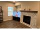 Inviting living room with a marble fireplace surround, TV, and light streaming from a nearby window at 14 Ledgemont Way, Acworth, GA 30101