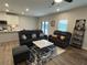Open-concept living room with modern furnishings, sleek marble coffee table, and access to the backyard at 14 Ledgemont Way, Acworth, GA 30101