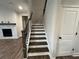 Dark wood staircase leading down towards the living room with a gas fireplace at 14 Ledgemont Way, Acworth, GA 30101
