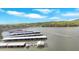 Wide aerial shot showcasing a vast lake with covered boat slips, surrounded by lush greenery and clear blue skies at 24 Allatoona Landing Rd #29, Cartersville, GA 30121