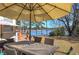Relaxing backyard patio with a table and chairs, shaded by an umbrella, with tranquil lake views at 24 Allatoona Landing Rd #29, Cartersville, GA 30121