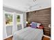 Cozy bedroom featuring wood accent wall, large windows, and comfortable bed at 24 Allatoona Landing Rd #29, Cartersville, GA 30121