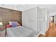 Compact bedroom features a wooden accent wall, hardwood floors, and modern ceiling fan at 24 Allatoona Landing Rd #29, Cartersville, GA 30121