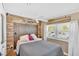 Comfortable bedroom with wood floors, stone accent wall, and modern ceiling fan at 24 Allatoona Landing Rd #29, Cartersville, GA 30121