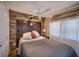 Charming bedroom with a stone accent wall, rustic wood headboard and vintage decor at 24 Allatoona Landing Rd #29, Cartersville, GA 30121