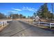 Welcoming community entrance with a paved road and decorative signage, framed by a white fence at 24 Allatoona Landing Rd #29, Cartersville, GA 30121
