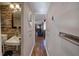 Hallway featuring stone accent wall, bathroom, and doorway to a living room with water views at 24 Allatoona Landing Rd #29, Cartersville, GA 30121