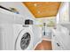 Bright laundry room featuring modern washer/dryer, wooden ceiling and ample cabinet space at 24 Allatoona Landing Rd #29, Cartersville, GA 30121