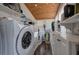 Functional laundry room with a full-sized washer, storage cabinets, shelves, and a tongue and groove ceiling at 24 Allatoona Landing Rd #29, Cartersville, GA 30121