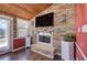 Comfortable living area boasting a fireplace, accent stone wall, mounted TV, and a beautiful wood-paneled ceiling at 24 Allatoona Landing Rd #29, Cartersville, GA 30121