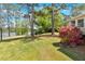 Spacious backyard with mature trees, beautiful landscaping, and lake view at 24 Allatoona Landing Rd #29, Cartersville, GA 30121