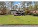 Picture of a home's sprawling green backyard with a patio, outdoor seating, a play structure, and a deck at 3473 Regalwoods Dr, Atlanta, GA 30340