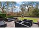 Well-manicured backyard with patio, sleek outdoor furniture, a fire pit, and a play structure for Gathering enjoyment at 3473 Regalwoods Dr, Atlanta, GA 30340
