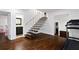 Open concept basement with wood staircase and steel railing, workout area, and a bathroom with a sleek design at 3473 Regalwoods Dr, Atlanta, GA 30340