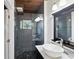 This bathroom has a modern vanity, vessel sink, frameless glass shower with a pebble stone floor at 3473 Regalwoods Dr, Atlanta, GA 30340