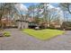 Beautiful gray house with a spacious backyard, well-kept lawn, black fence, and modern outdoor seating area at 3473 Regalwoods Dr, Atlanta, GA 30340