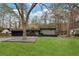 Charming single-story home with lush front lawn, mature trees, and an attached garage at 3473 Regalwoods Dr, Atlanta, GA 30340