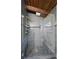 Walk-in shower with pebble stone floor and grey tiled walls, features a built-in bench at 3473 Regalwoods Dr, Atlanta, GA 30340