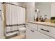 A bathroom with a single vanity, shower curtain, and neutral colors at 4121 Townsend Ln, Atlanta, GA 30346