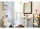 Chic powder room with pedestal sink, modern fixtures, and stylish decor at 4121 Townsend Ln, Atlanta, GA 30346