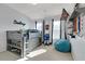 A bedroom with a unique loft bed, bean bag chair and large windows at 4121 Townsend Ln, Atlanta, GA 30346