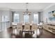 Elegant dining room with hardwood floors, large windows, modern chandelier, and neutral decor at 4121 Townsend Ln, Atlanta, GA 30346